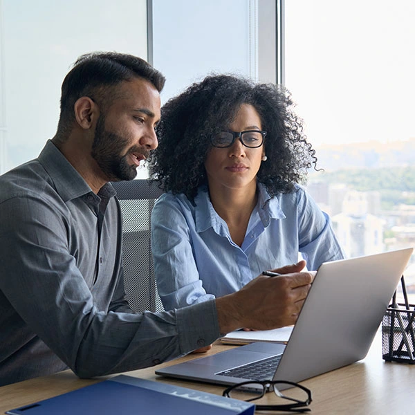 Business professionals reviewing insolvency options and intellectual property asset valuation strategies in a modern office setting.